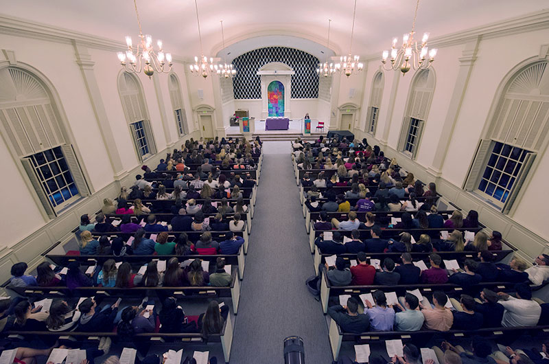 The interior of Snidow Chapel filled with people sitting in the pews