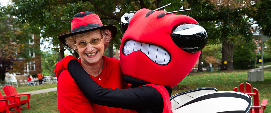 President Alison Morrison-Shetlar hugs the University of Lynchburg mascot during Homecoming