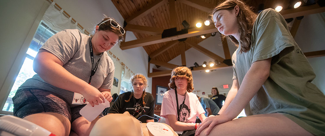 An instructor with three students during CPR training