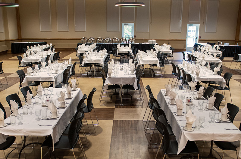 Memorial Ballroom with long, rectangular tables that are set for a large lunch gathering