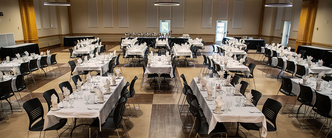 Memorial Ballroom with long, rectangular tables that are set for a large lunch gathering