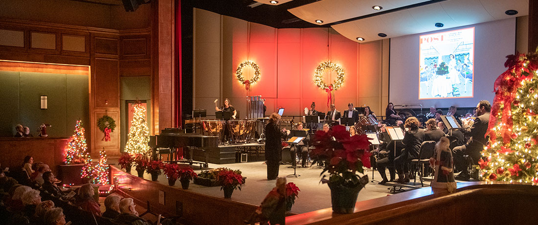 An orchestra performing Christmas music in Sydnor Performance Hall